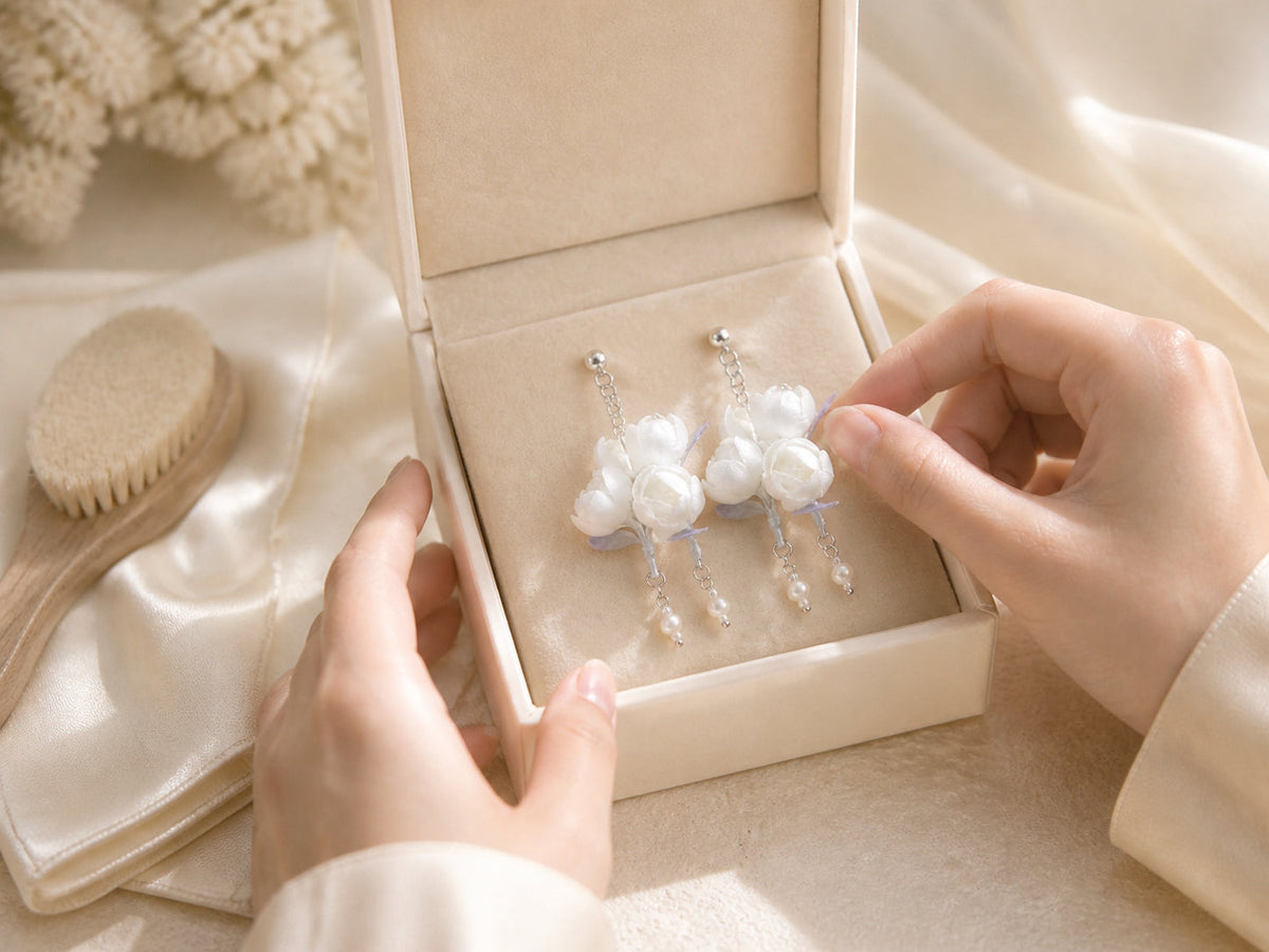 White jasmine Ronghua earrings stored gently in a jewelry box