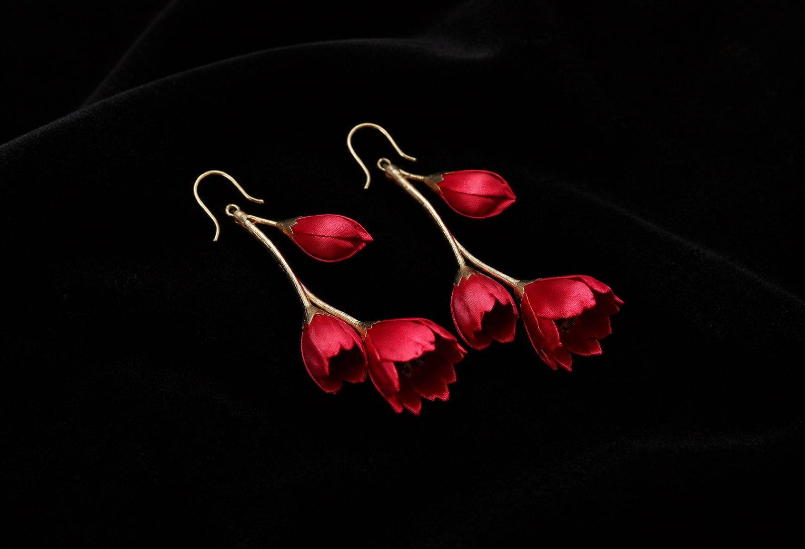 Statement earrings displayed on dark velvet for the HUAVELLE earrings collection