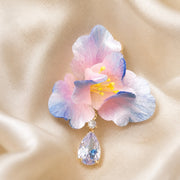Close detail of one blush blue iris Ronghua earring and zircon drop