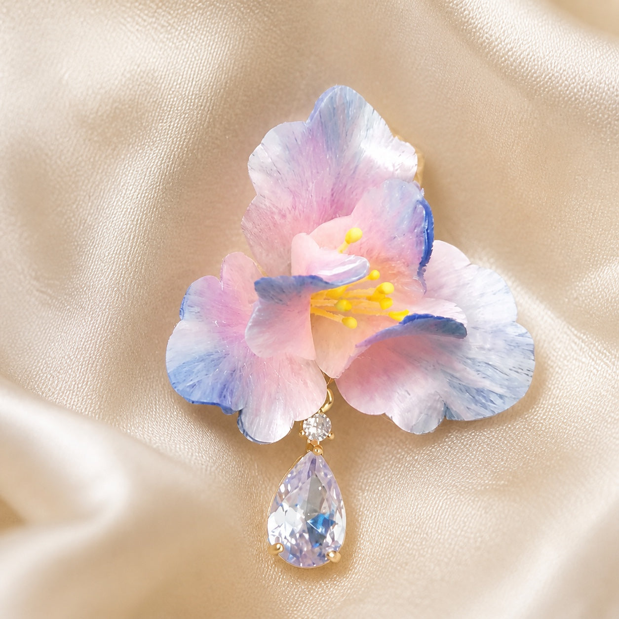 Close detail of one blush blue iris Ronghua earring and zircon drop
