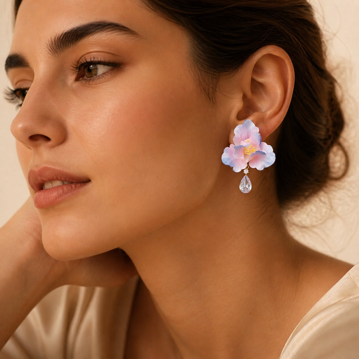 Woman wearing one blush blue iris Ronghua zircon earring