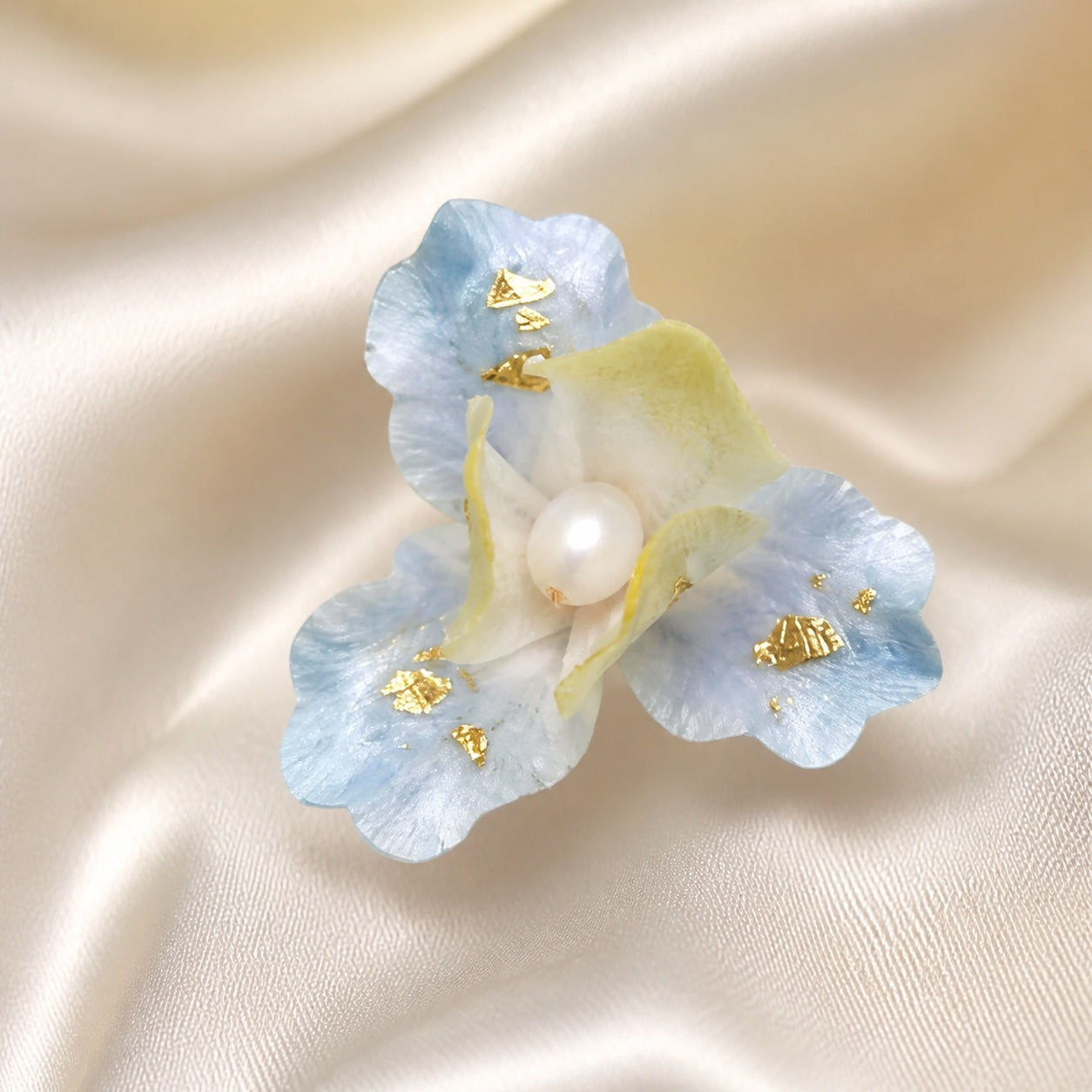 Close detail of one frosted iris Ronghua stud earring with pearl center