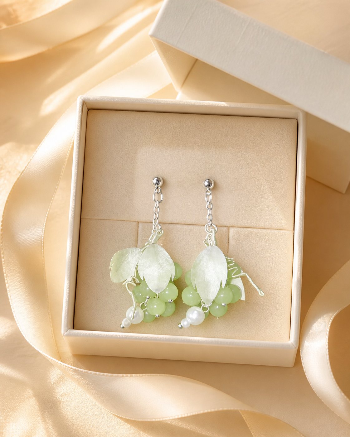 HUAVELLE Green Grape Ronghua earrings presented in a cream jewelry gift box