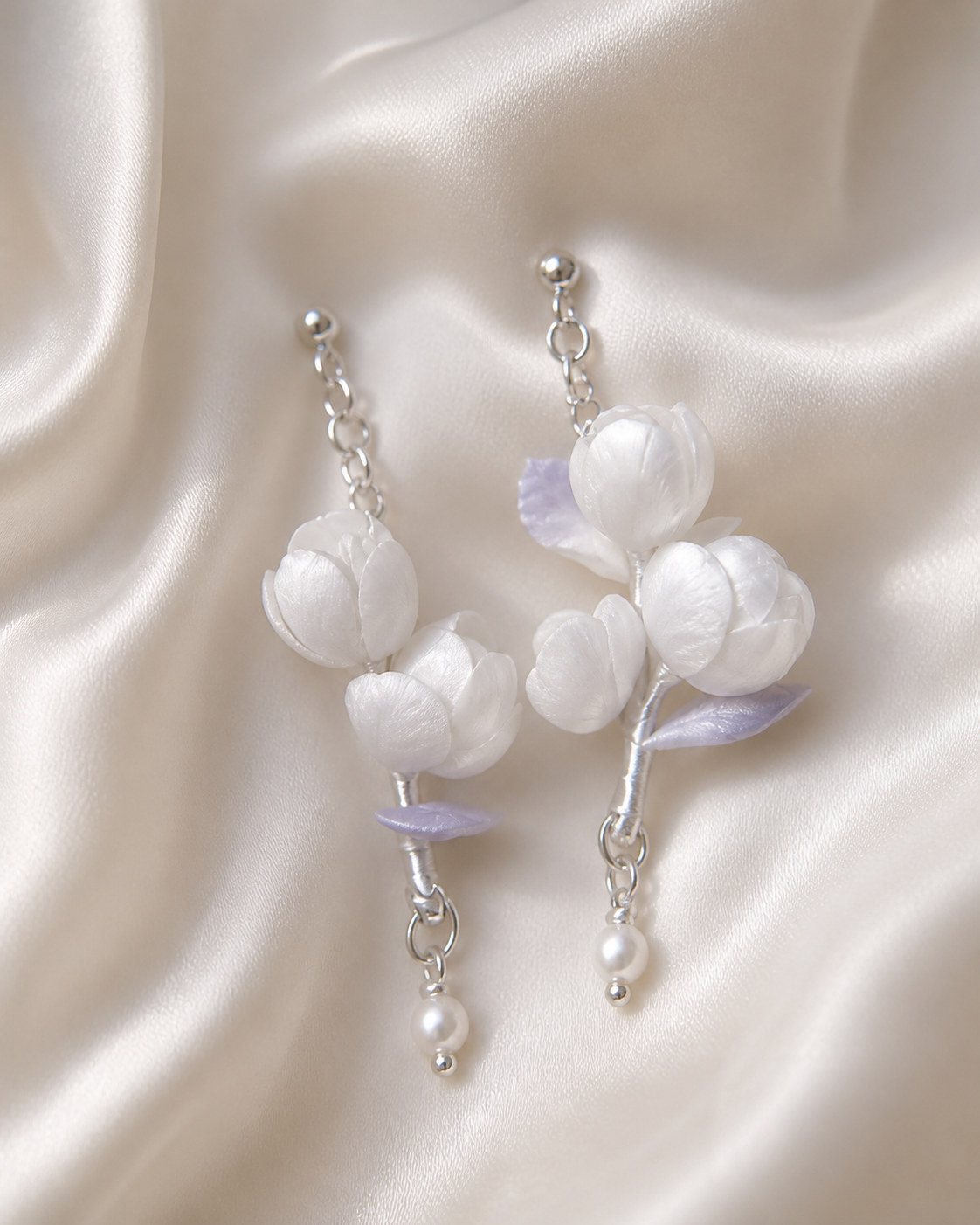 Close detail of white mulberry silk jasmine blossoms and pearl drops