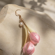 Close detail of one pink peony Ronghua silk flower earring