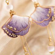 Close-up of purple ombre silk petals and gold-tone wirework on HUAVELLE earrings