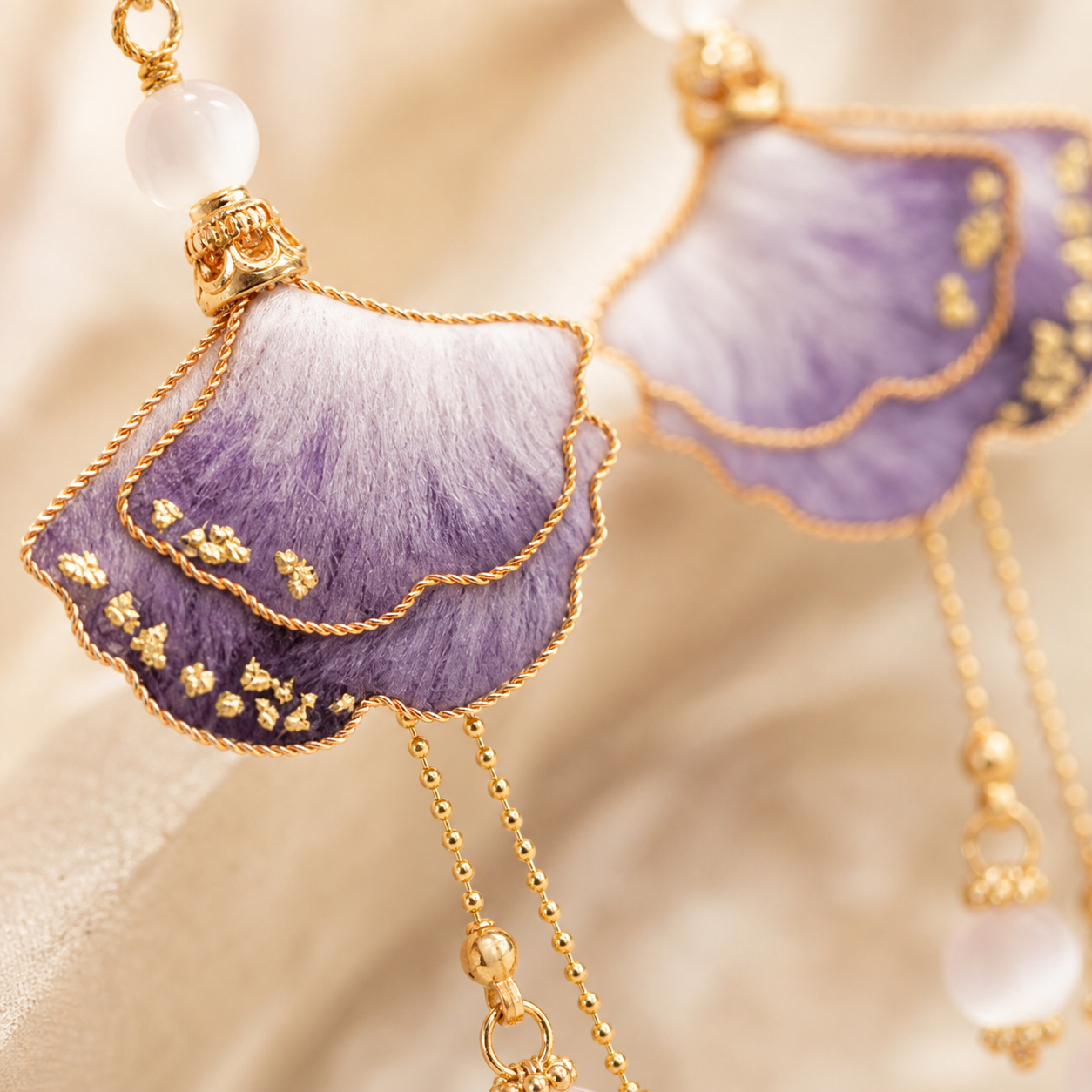 Close-up of purple ombre silk petals and gold-tone wirework on HUAVELLE earrings