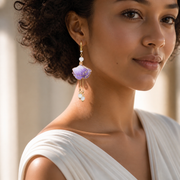 Woman wearing HUAVELLE Purple Ginkgo silk flower statement earrings