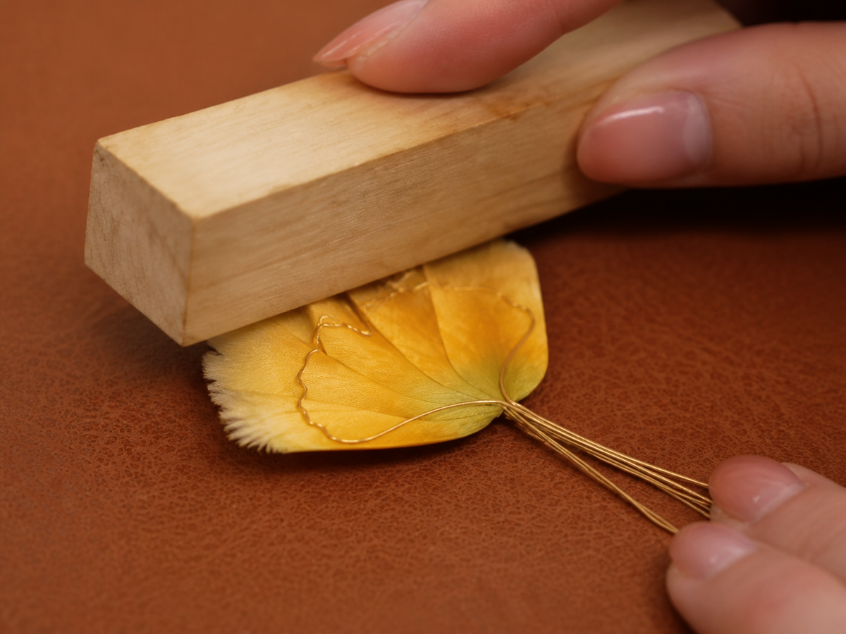 Artisan setting prepared silk into a wire-edged Ronghua petal