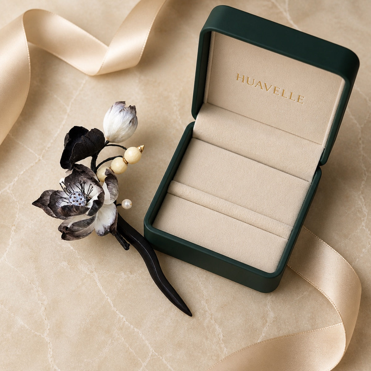 Ink Lotus Ronghua hairpin beside a green HUAVELLE presentation box